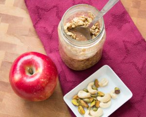 Sue's Overnight Oats with nuts and an apple