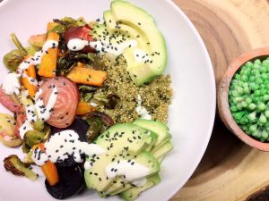 Quinoa bowl with roasted veggies, avocado, and garlic aioli