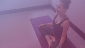 Woman Sitting Cross Legged on Yoga Mat - Purple Overlay - Kind Living with Sue Sinclair
