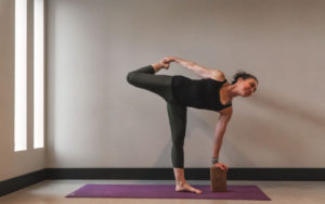 Women Doing yoga with yoga block - Kind Living - Orillia