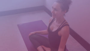 Woman Sitting Cross Legged on Yoga Mat - Purple Overlay - Kind Living with Sue Sinclair